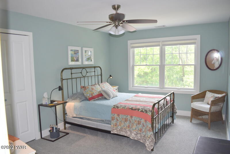 549 Finn Swamp Road Lakeville, PA 18438 - Photo 16 of 35 a bedroom with a bed and a chandelier