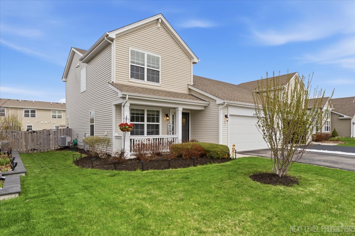 270 Norfolk Lane Pingree Grove, IL 60140 - Photo 1 of 25 a front view of a house with garden and porch