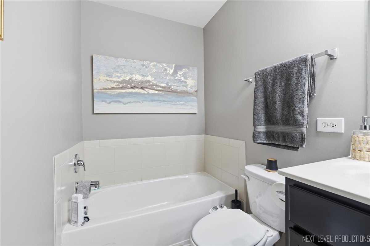 270 Norfolk Lane Pingree Grove, IL 60140 - Photo 19 of 25 a white bath tub sitting next to a white toilet and a sink