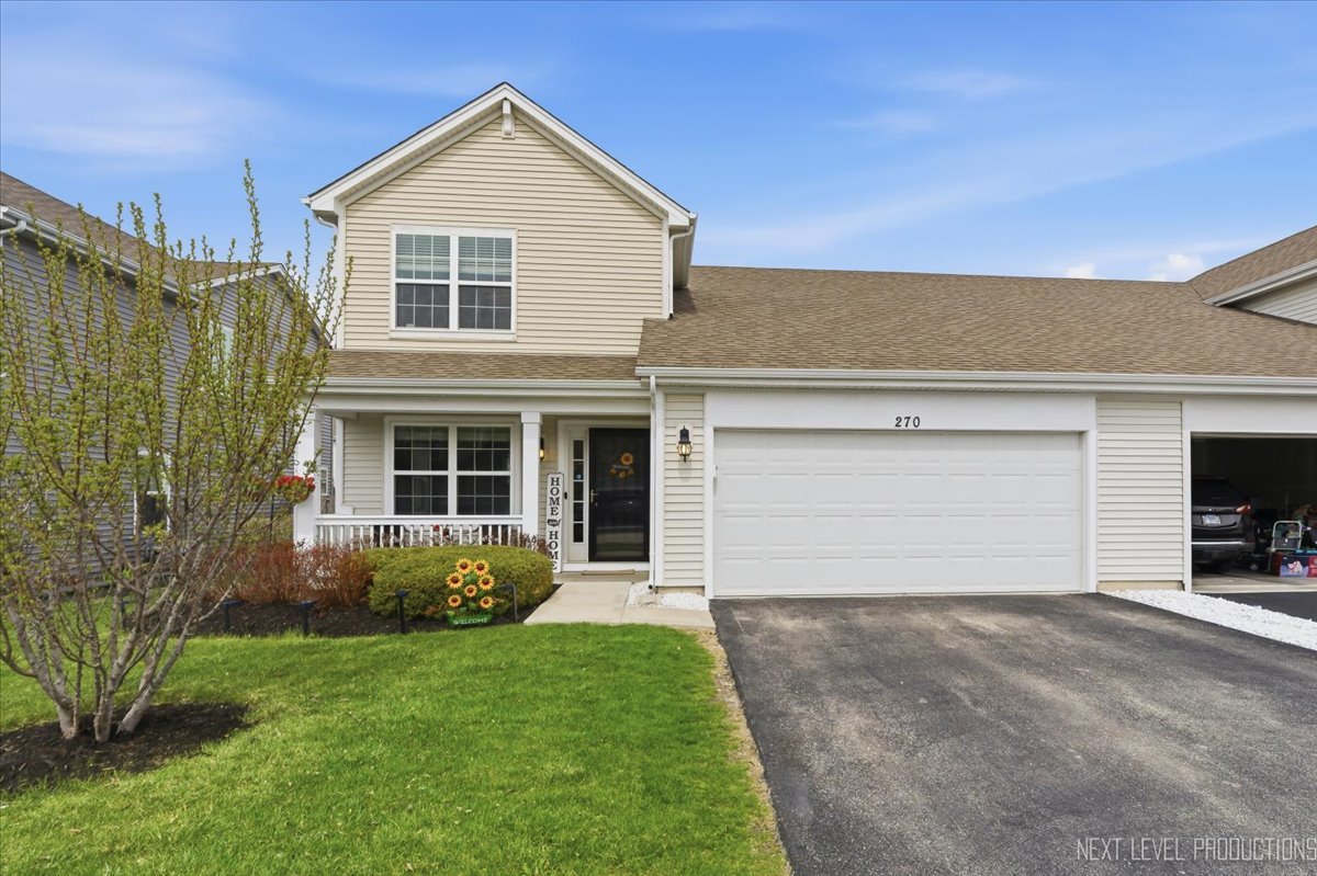 270 Norfolk Lane Pingree Grove, IL 60140 - Photo 2 of 25 a view of a house with a yard and garage