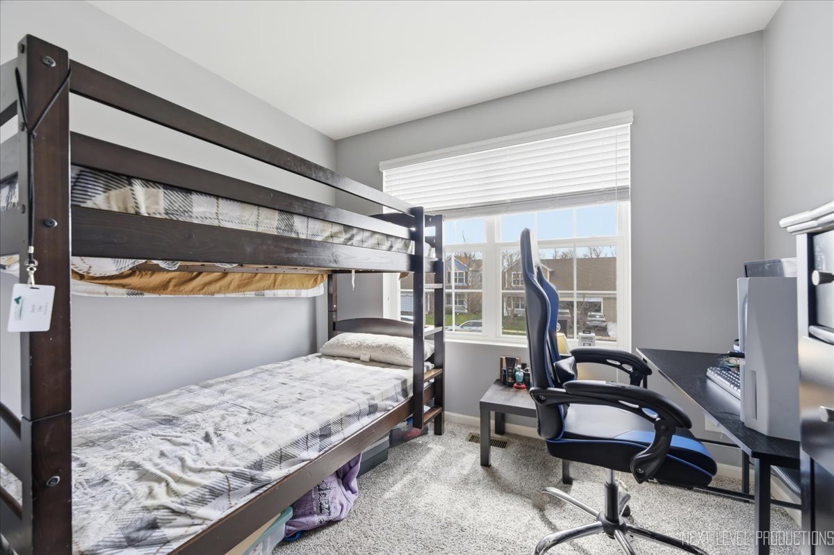 270 Norfolk Lane Pingree Grove, IL 60140 - Photo 21 of 25 a bedroom with a bed a desk and chair with the wooden floor