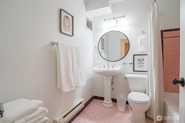 a bathroom with a toilet sink vanity and mirror