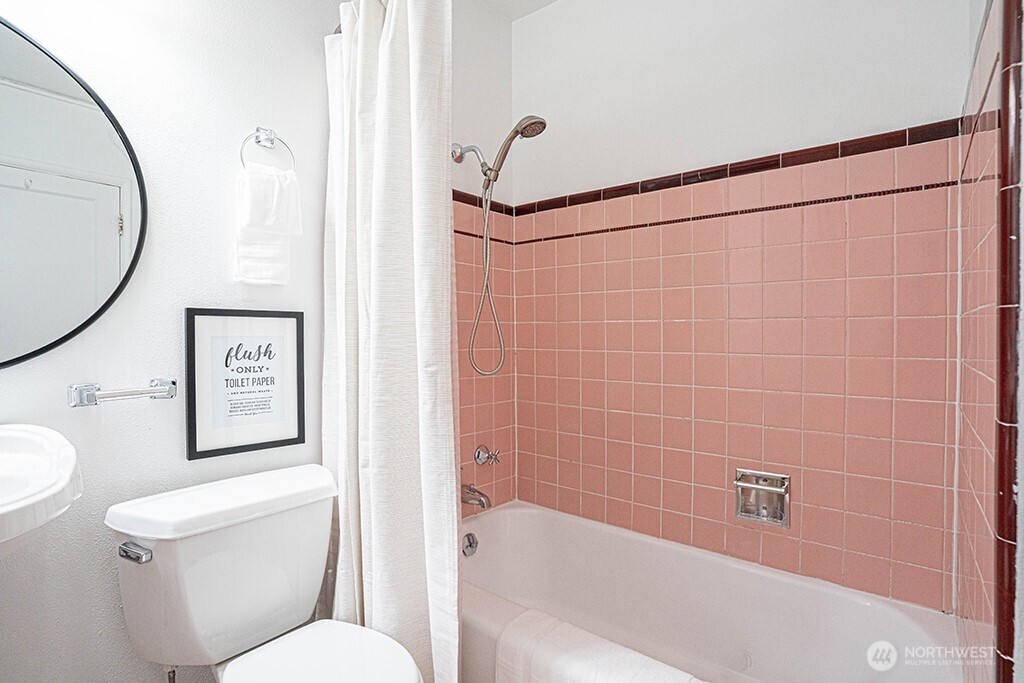 4027 Beach Drive Southwest, Unit 1 Seattle, WA 98116 - Photo 19 of 28 a bathroom with a toilet and a shower