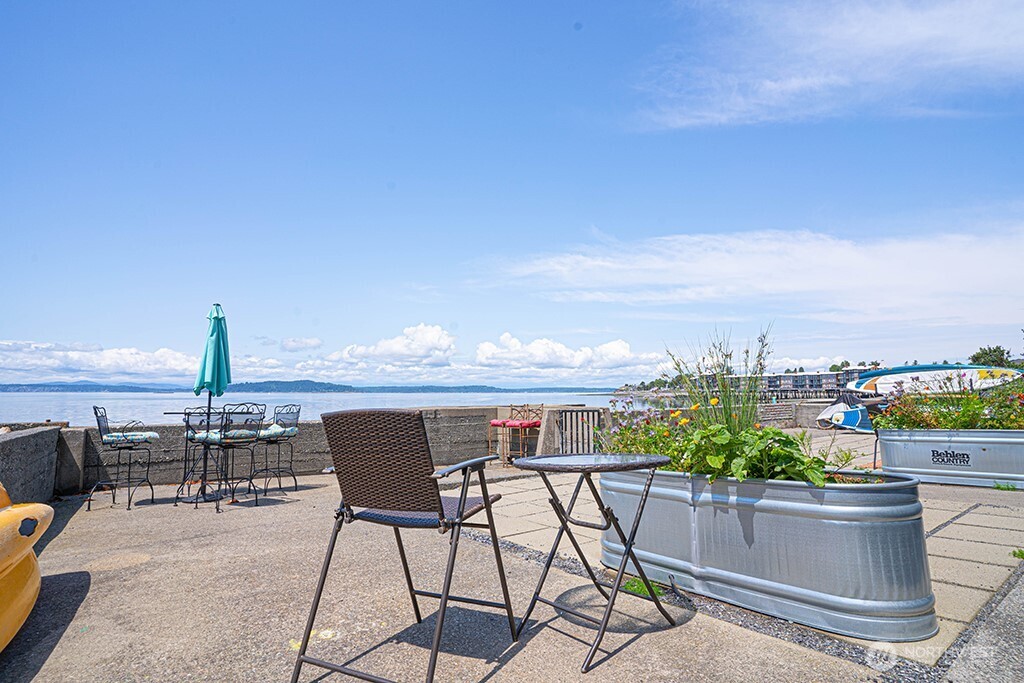 4027 Beach Drive Southwest, Unit 1 Seattle, WA 98116 - Photo 22 of 28 a view of a terrace with furniture and a garden