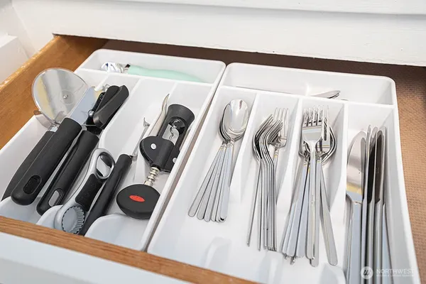 a kitchen with white cabinets and a sink
