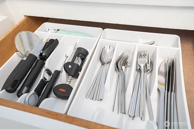 a kitchen with white cabinets and a sink