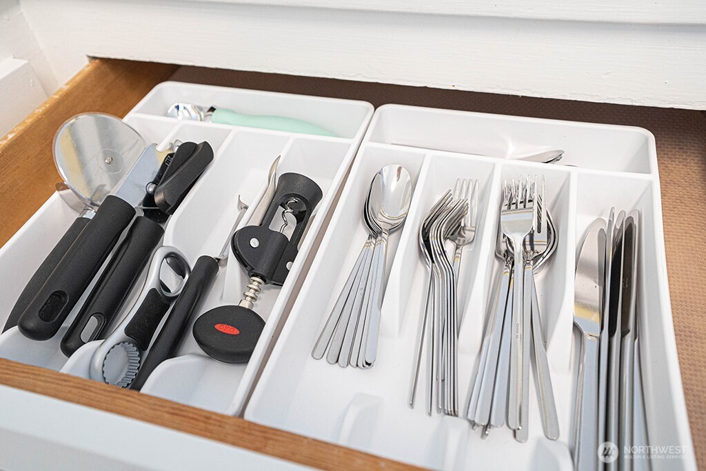 4027 Beach Drive Southwest, Unit 1 Seattle, WA 98116 - Photo 27 of 28 a view of walk in closet with clothes and shoes