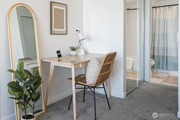 a dining room with furniture and potted plants