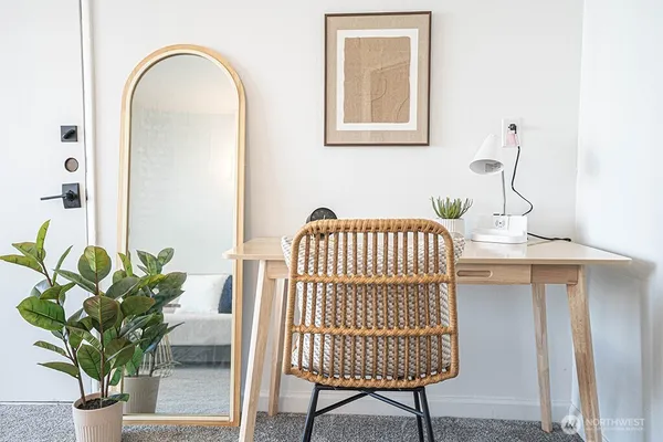 a view of a dining room with furniture and a potted plant