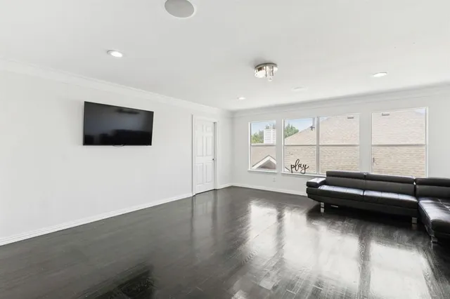 a view of a livingroom with furniture and flat screen tv