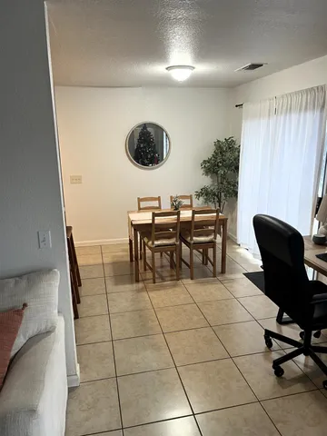 a dining room with furniture and a clock