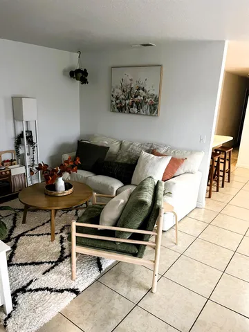 a living room with a table and chairs