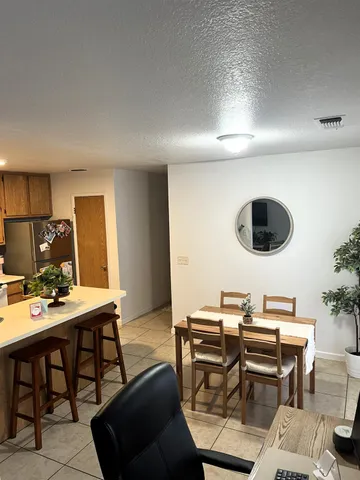 a view of a dining room with furniture and chandelier