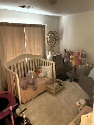 a bedroom with furniture and a window