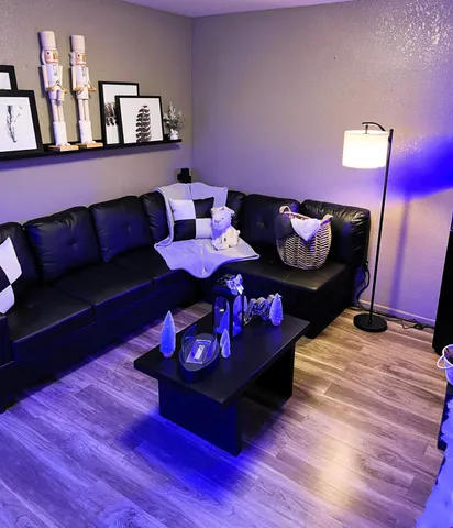 a living room with furniture and wooden floor