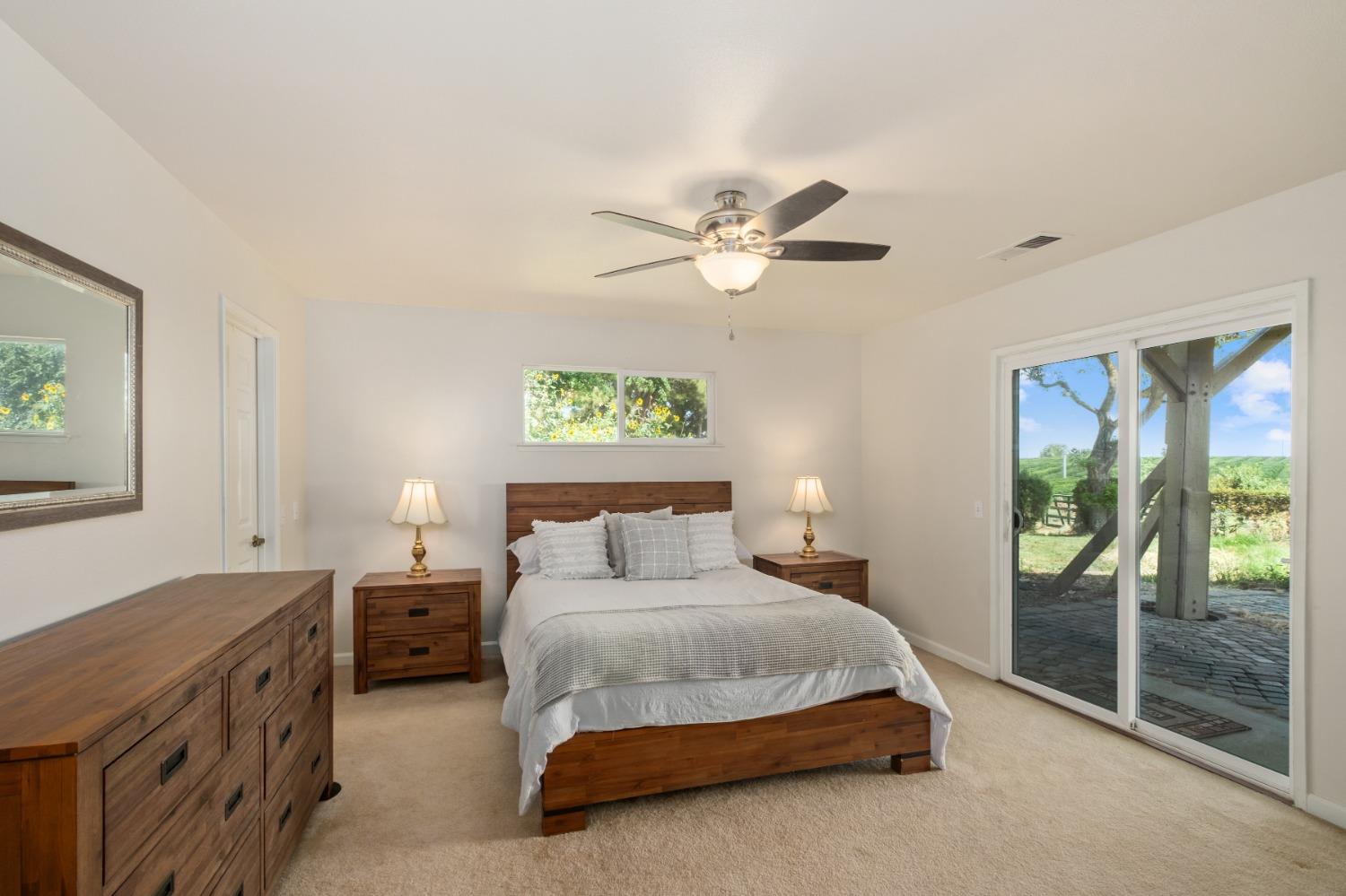 29001 Ave 22 Madera, CA 93638 - Photo 12 of 31 a bedroom with a bed and a chandelier