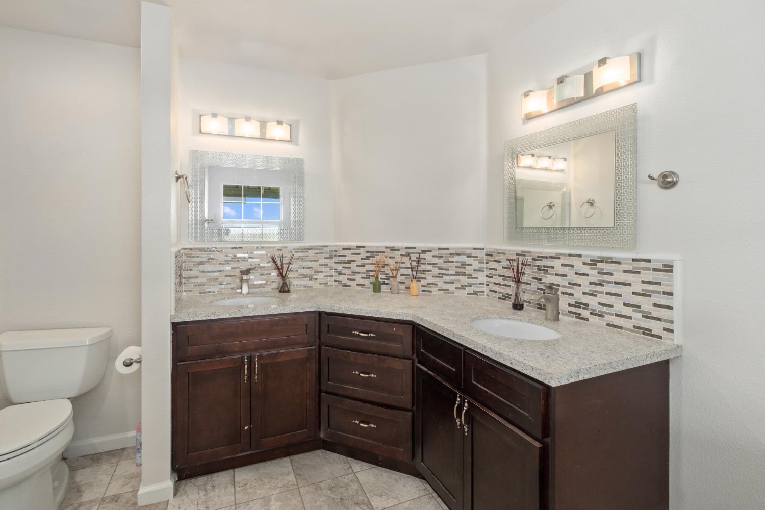 29001 Ave 22 Madera, CA 93638 - Photo 13 of 31 a bathroom with a sink and a toilet