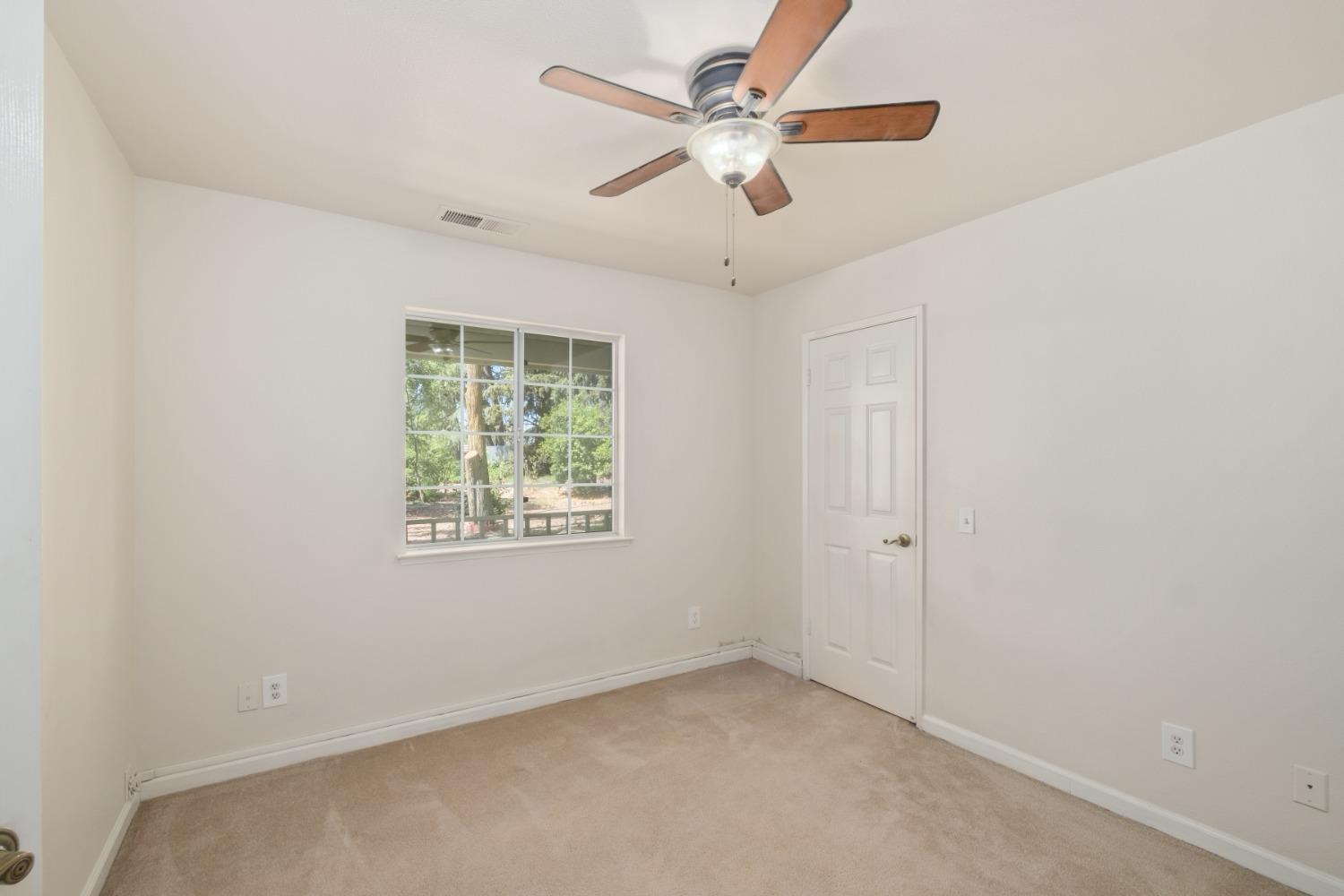 29001 Ave 22 Madera, CA 93638 - Photo 18 of 31 an empty room with a window and a fan