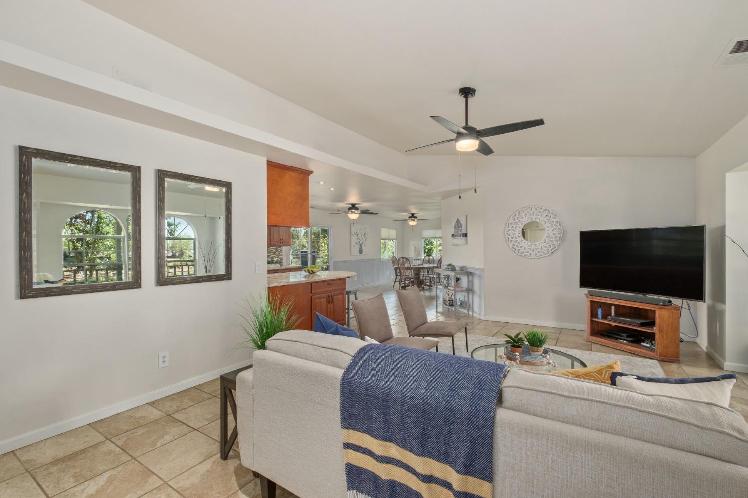 29001 Ave 22 Madera, CA 93638 - Photo 3 of 31 a living room with furniture and a flat screen tv
