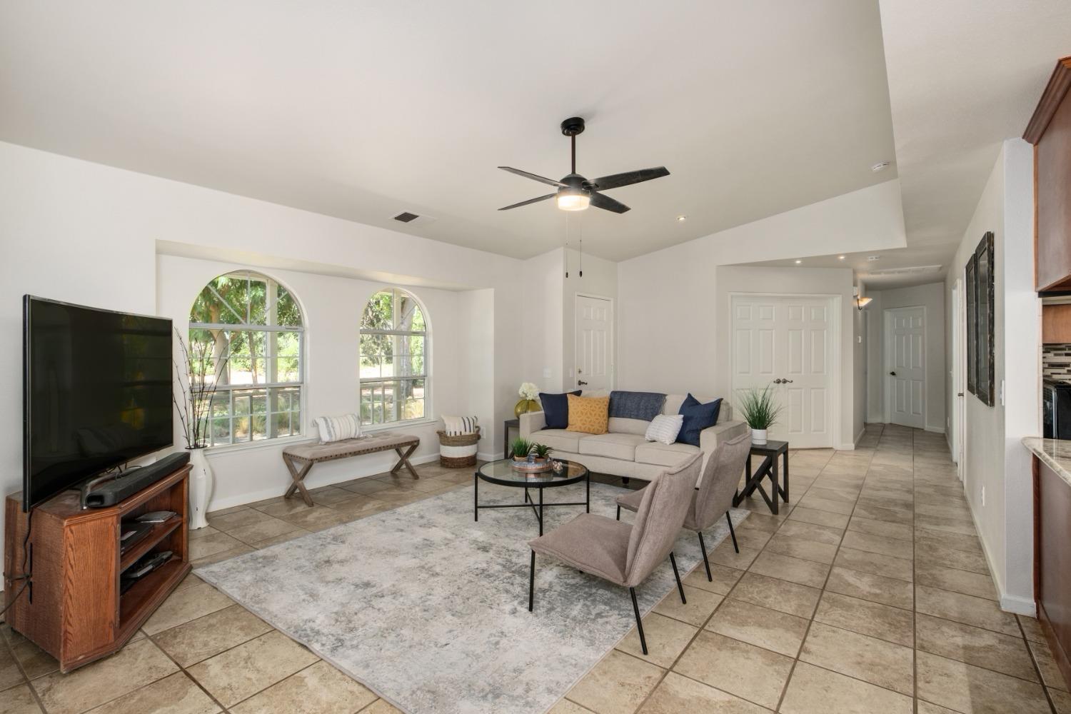 29001 Ave 22 Madera, CA 93638 - Photo 5 of 31 a living room with furniture and a flat screen tv