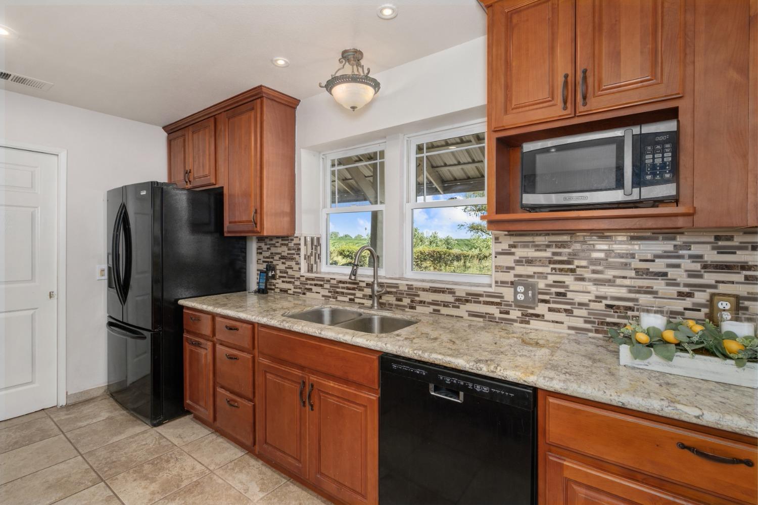 29001 Ave 22 Madera, CA 93638 - Photo 8 of 31 a kitchen with stainless steel appliances granite countertop a refrigerator and a sink