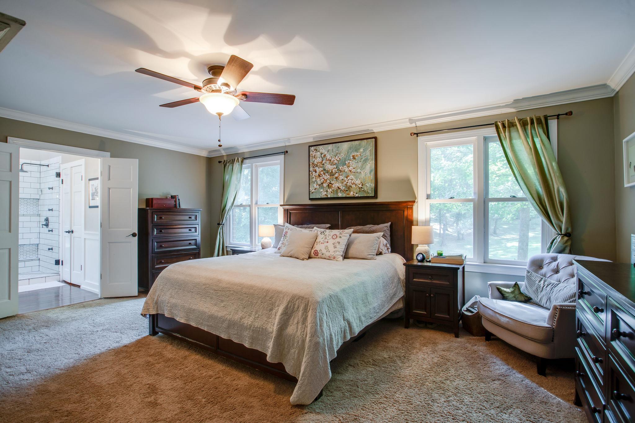 608 Rice Hill Road Nolensville, TN 37135 - Photo 12 of 30 a bedroom with a bed and a chandelier
