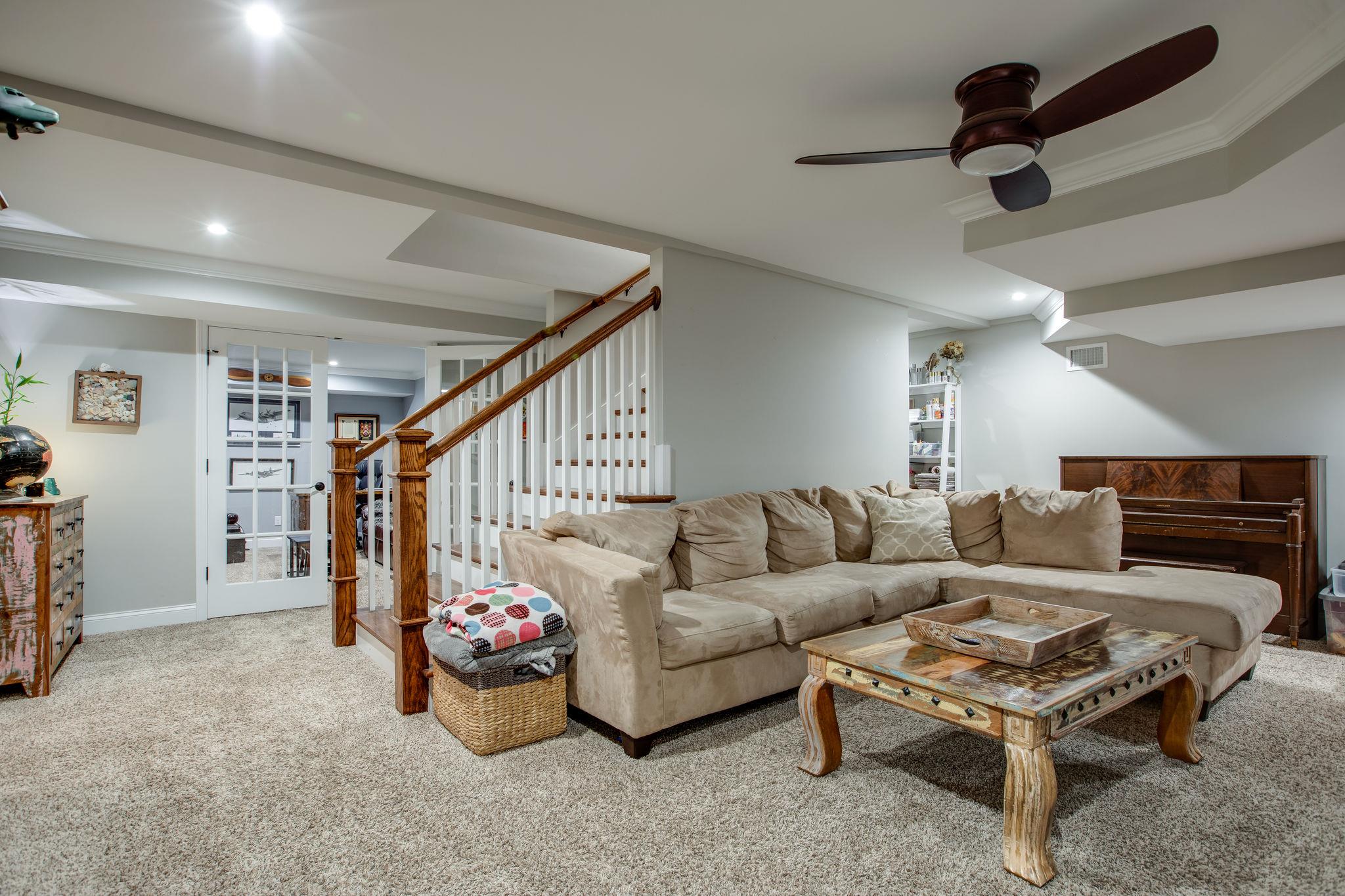 608 Rice Hill Road Nolensville, TN 37135 - Photo 20 of 30 a living room with furniture and a chandelier
