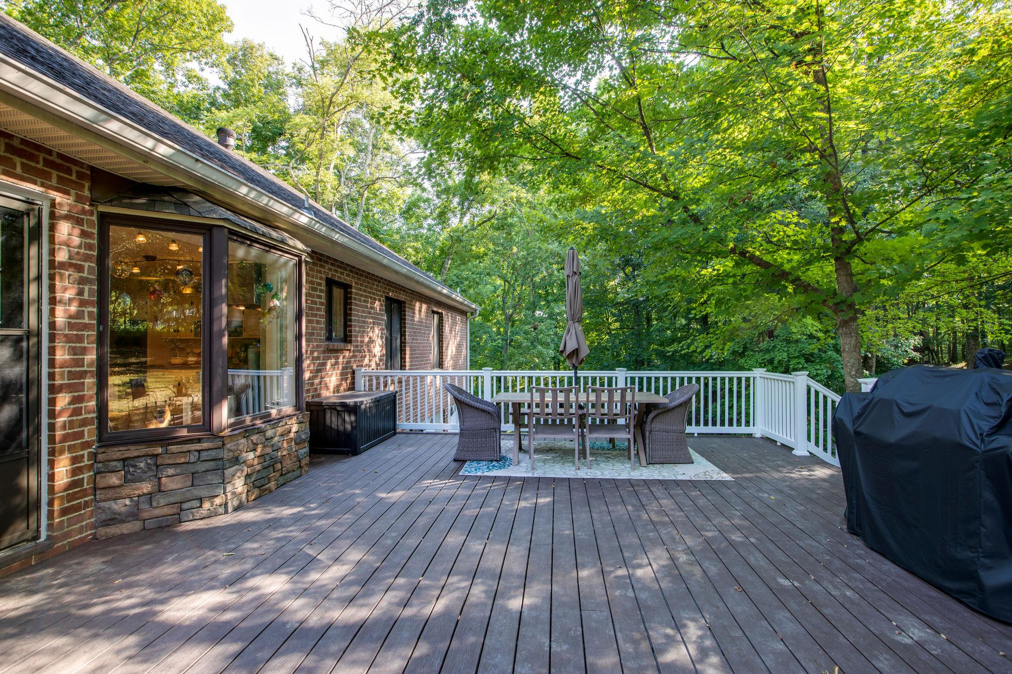 608 Rice Hill Road Nolensville, TN 37135 - Photo 24 of 30 a wooden bench sitting in front of a building