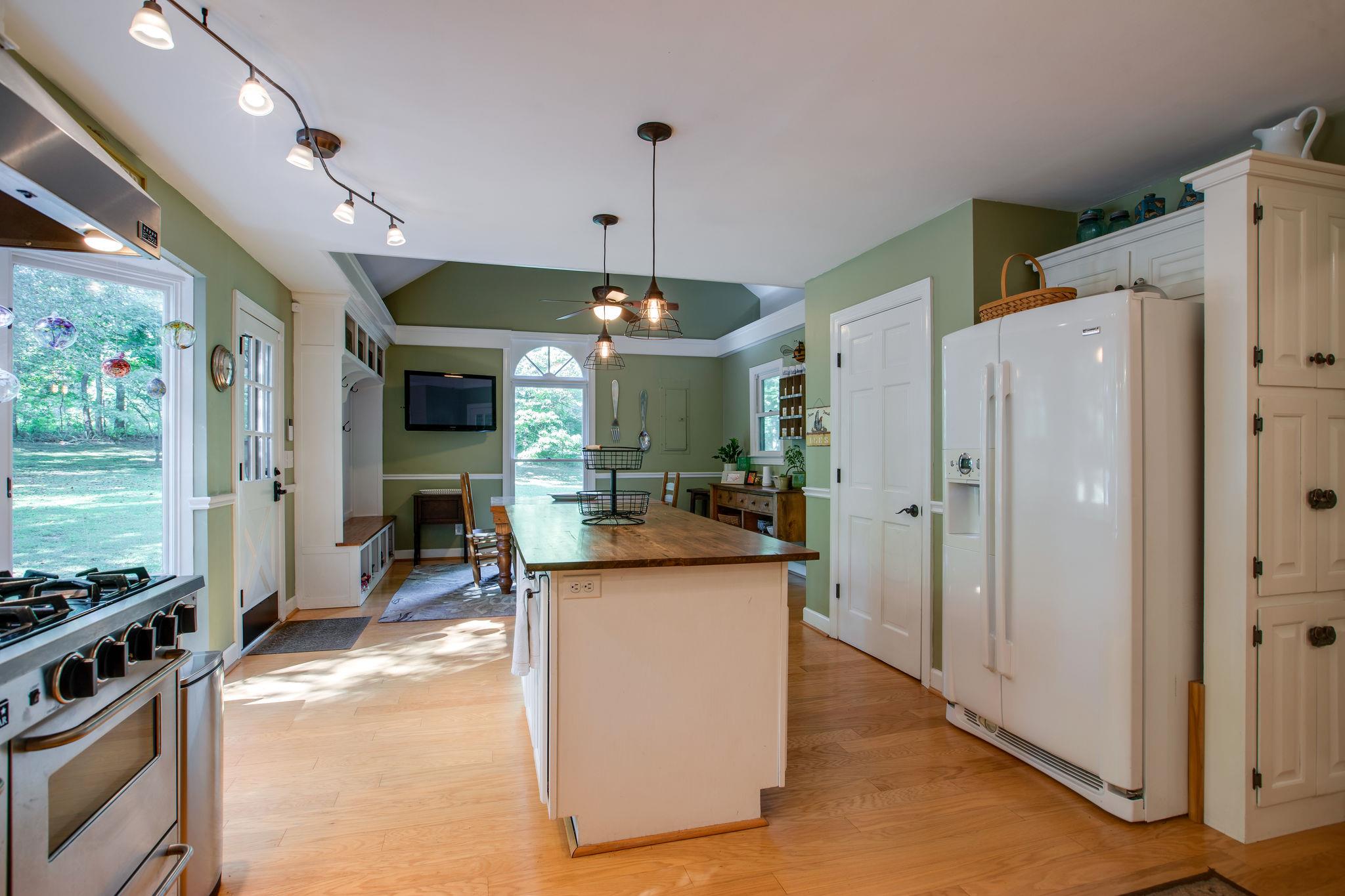 608 Rice Hill Road Nolensville, TN 37135 - Photo 9 of 30 a view of a kitchen with kitchen island stainless steel appliances a stove and refrigerator