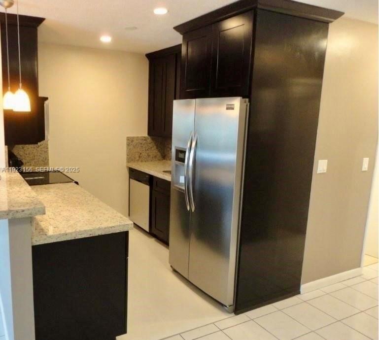 2665 Middle River Drive, Unit 7 Fort Lauderdale, FL 33306 - Photo 2 of 8 a kitchen with a refrigerator and a microwave