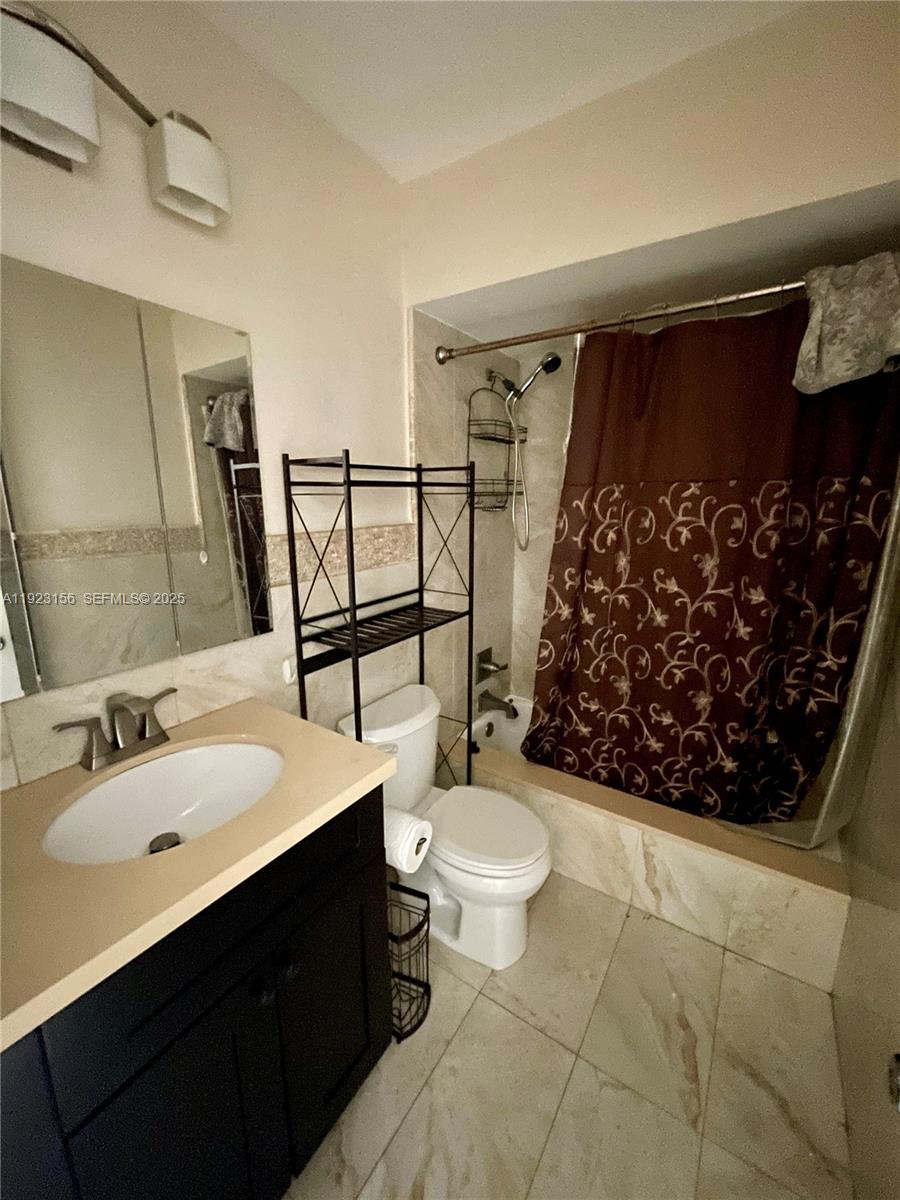 2665 Middle River Drive, Unit 7 Fort Lauderdale, FL 33306 - Photo 5 of 8 a bathroom with a sink toilet and shower