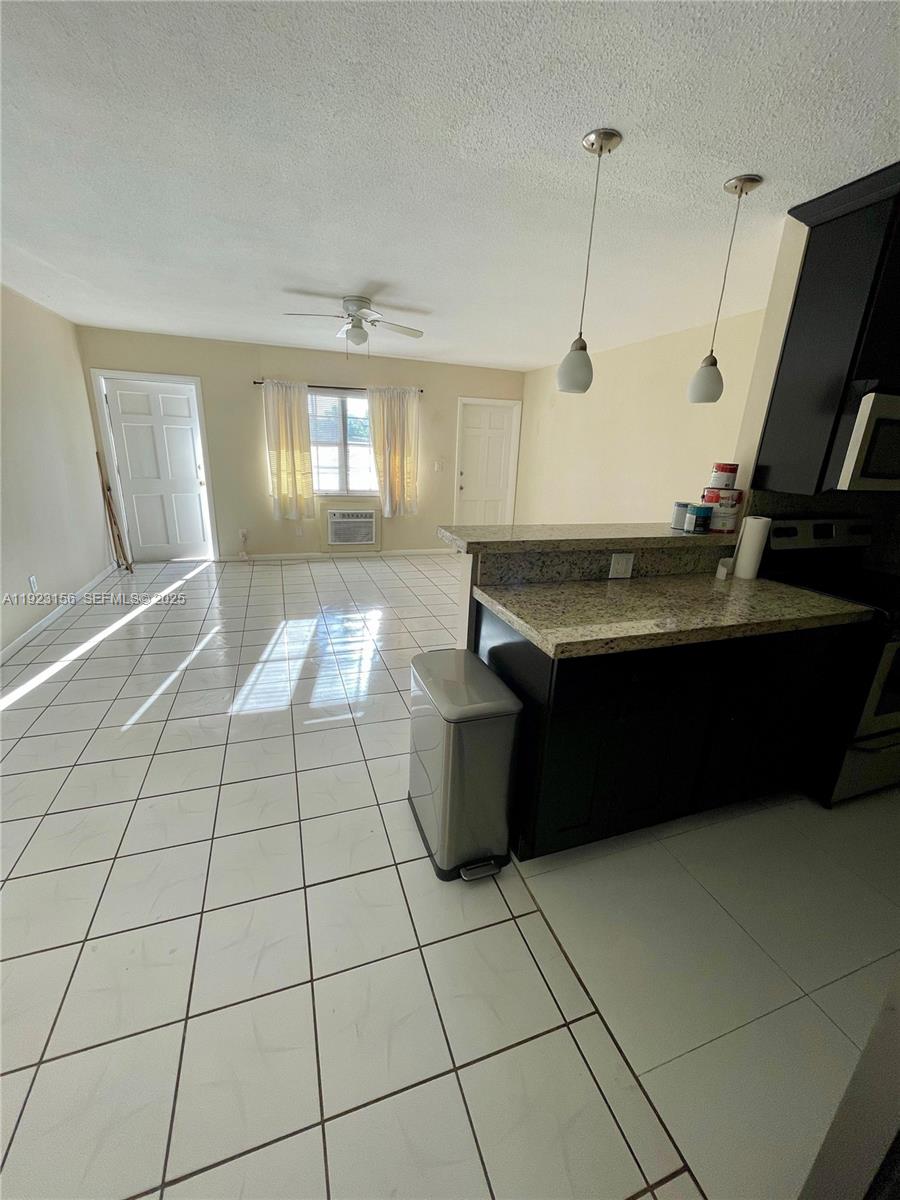2665 Middle River Drive, Unit 7 Fort Lauderdale, FL 33306 - Photo 6 of 8 a room with a sink a granite counter top and a stove