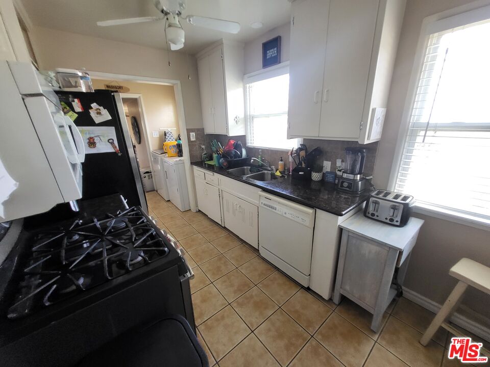 2831 Pine Street Bakersfield, CA 93301 - Photo 12 of 33 a kitchen with sink a stove and cabinets