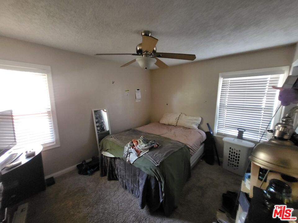 2831 Pine Street Bakersfield, CA 93301 - Photo 19 of 33 a bed sitting in a bedroom next to a window