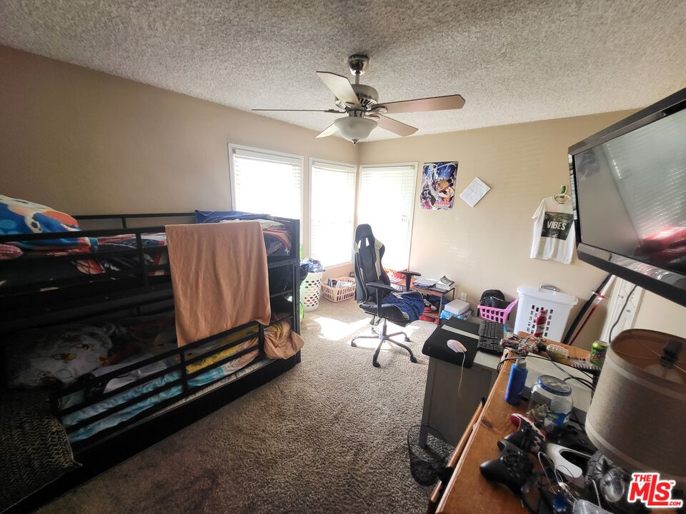 2831 Pine Street Bakersfield, CA 93301 - Photo 23 of 33 a living room with furniture gym equipment and a flat screen tv