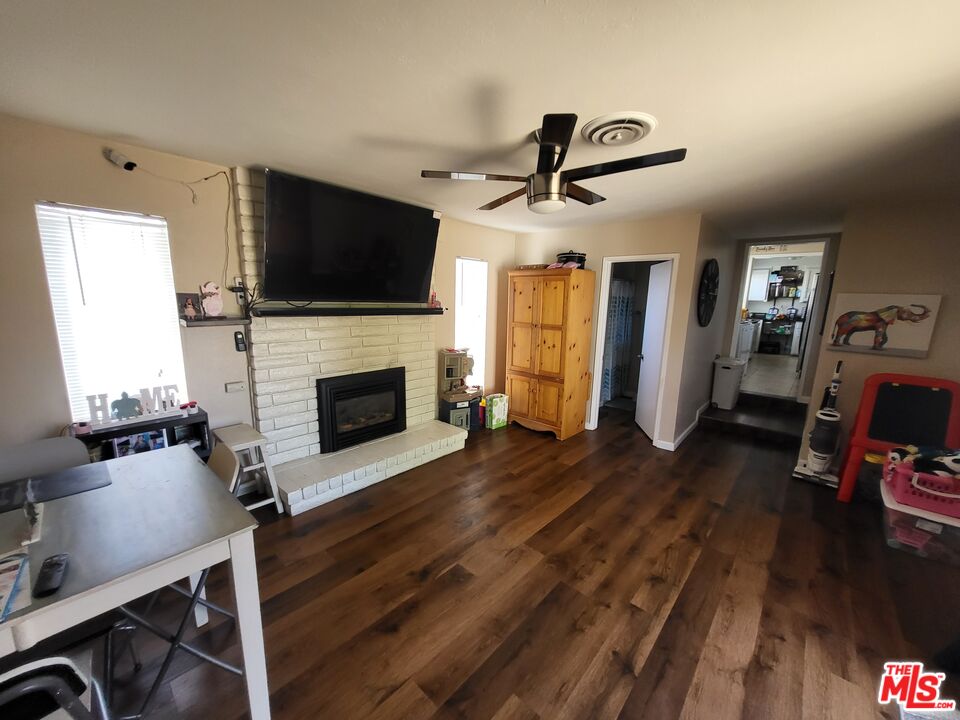 2831 Pine Street Bakersfield, CA 93301 - Photo 27 of 33 a living room with furniture fireplace and flat screen tv