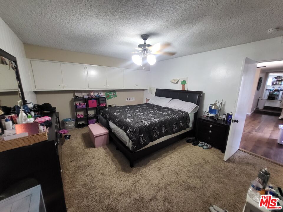 2831 Pine Street Bakersfield, CA 93301 - Photo 32 of 33 a bed room with a bed and a chandelier