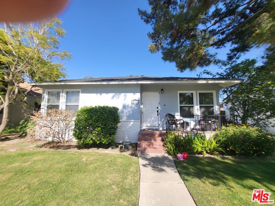 2831 Pine Street Bakersfield, CA 93301 - Photo 5 of 33 a front view of a house with a yard and potted plants