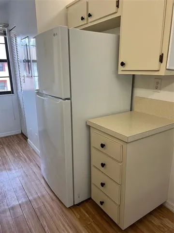 a utility room with cabinets washer and dryer