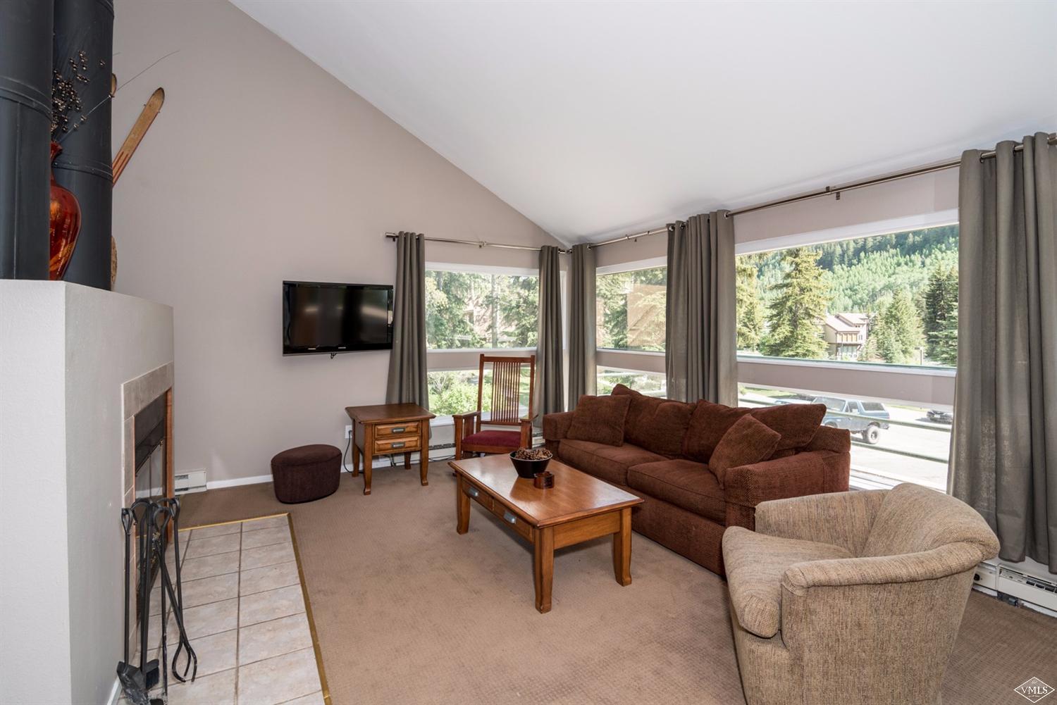 3901 Big Horn Road, Unit 2H Vail, CO 81657 - Photo 3 of 16 a living room with furniture and a flat screen tv