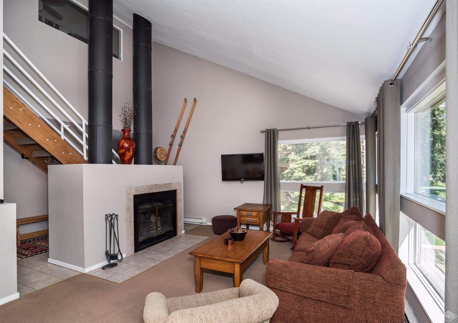 3901 Big Horn Road, Unit 2H Vail, CO 81657 - Photo 4 of 16 a living room with furniture a fireplace and a flat screen tv