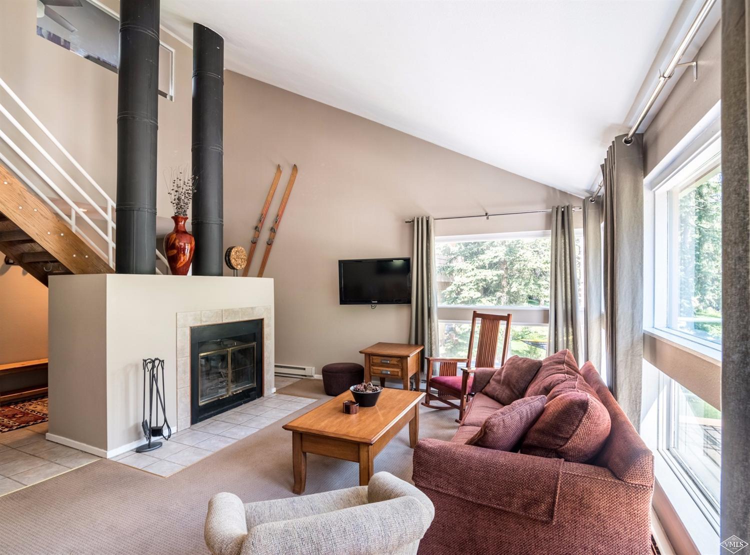 3901 Big Horn Road, Unit 2H Vail, CO 81657 - Photo 5 of 16 a living room with furniture a fireplace and a flat screen tv