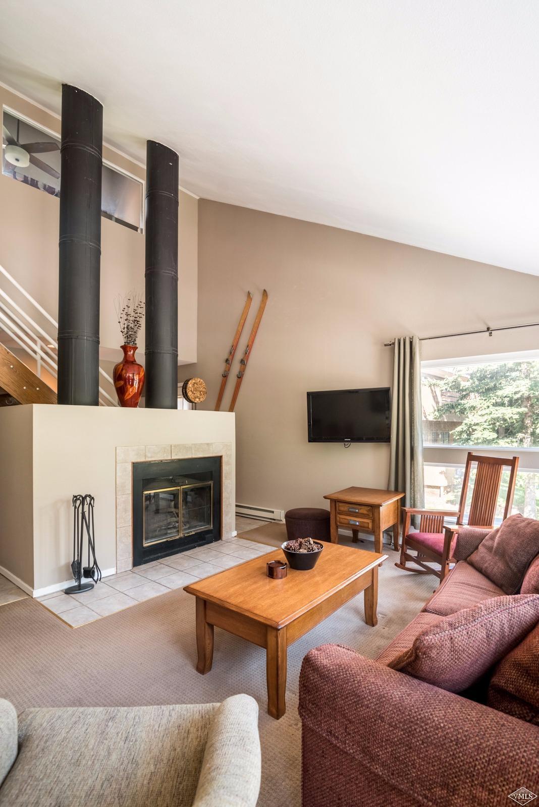 3901 Big Horn Road, Unit 2H Vail, CO 81657 - Photo 6 of 16 a living room with furniture fireplace and a large window