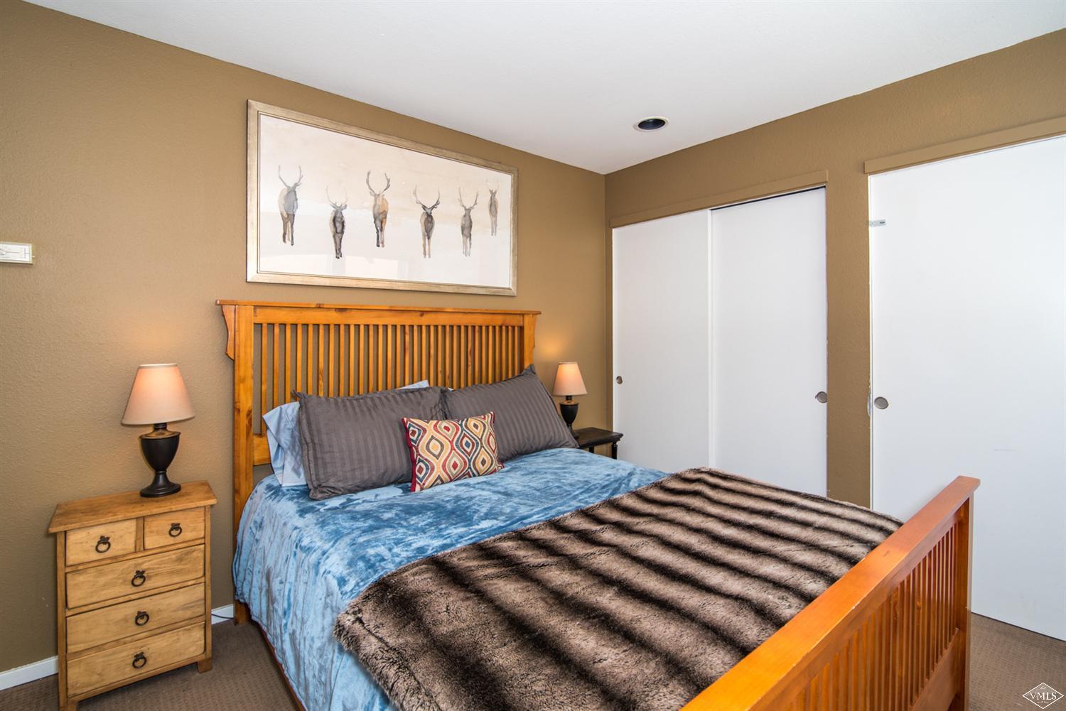 3901 Big Horn Road, Unit 2H Vail, CO 81657 - Photo 10 of 16 a bedroom with a bed and a lamp on the dresser