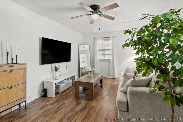 a living room with furniture and a flat screen tv