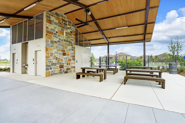 a view of swimming pool with outdoor seating and plants