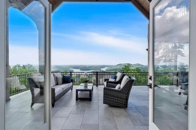 a view of a dining room with furniture a chandelier and wooden floor