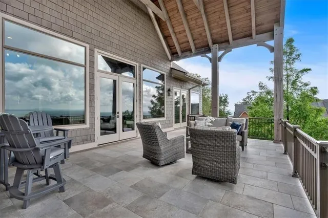 a bedroom with a bed and a large window with outer view