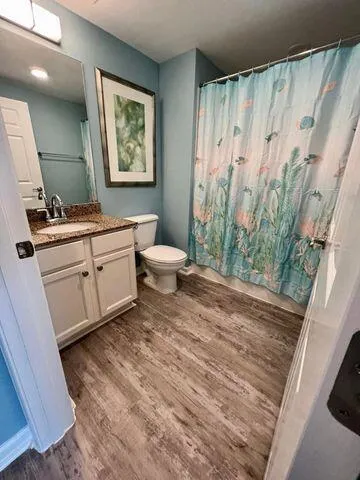 a bedroom with a bed and a night stand