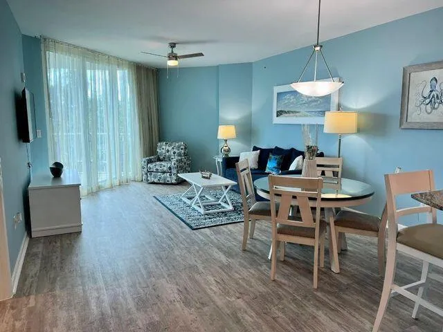 a dining room with furniture and wooden floor